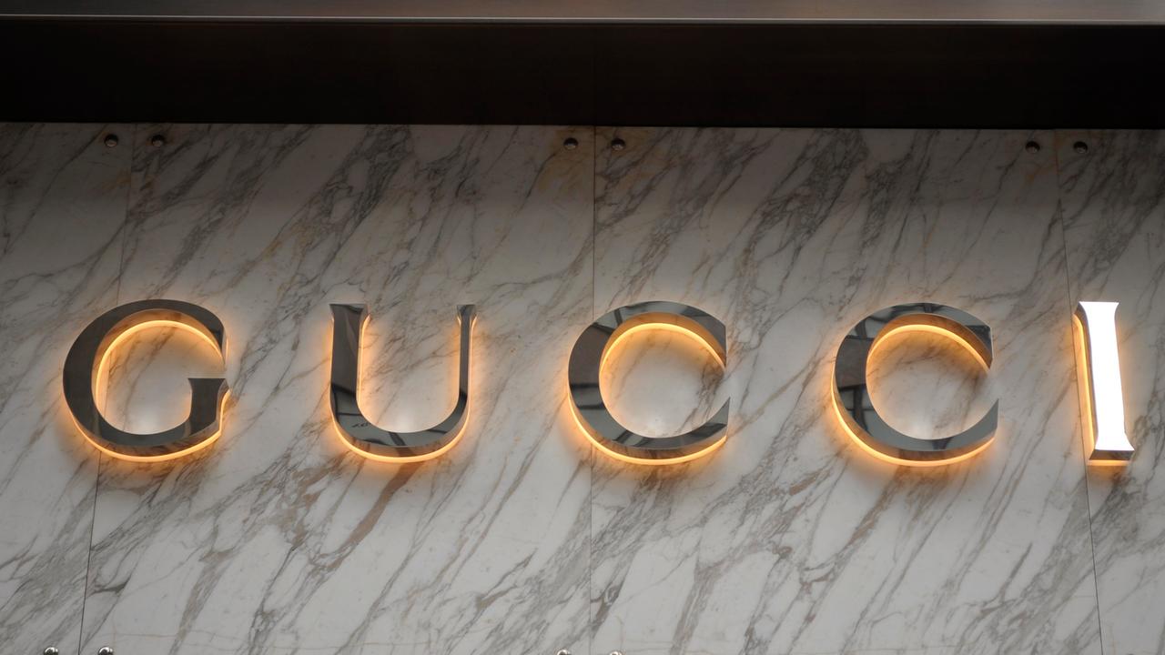 Die Gucci-Buchstaben in Gold auf einer Marmorplatte.