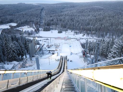 Wir sehen eine Skisprungschanze aus Sicht des Skispringers. 