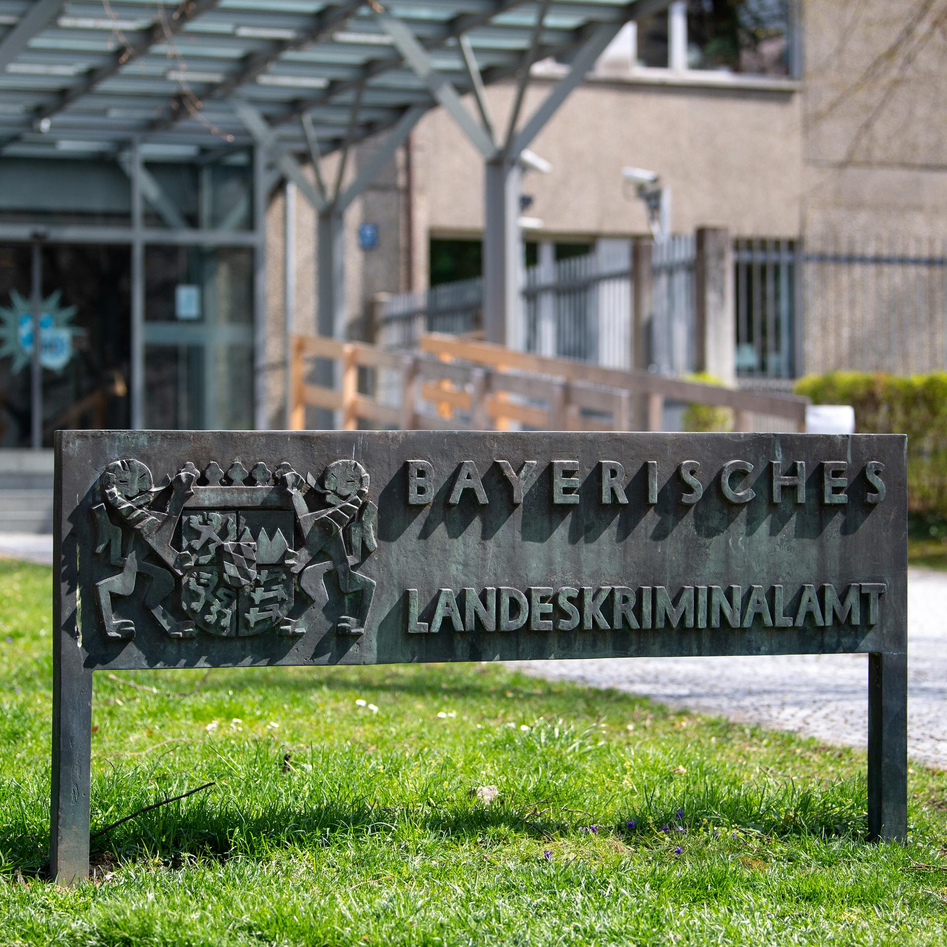 Ein Schild mit der Aufschrift "Bayerisches Landeskriminalamt" steht vor dem Eingang am Landeskriminalamt (LKA) in München. 