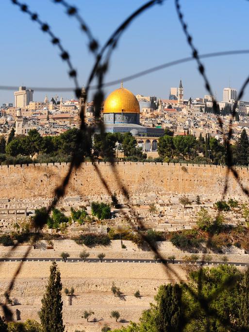 View from the Mount of Olives on the dome of the rock and ancient cemetery through the barbed wire, as a symbol of Palestine Israeli conflict