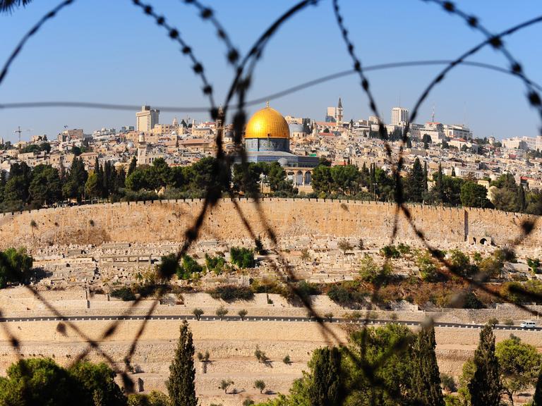View from the Mount of Olives on the dome of the rock and ancient cemetery through the barbed wire, as a symbol of Palestine Israeli conflict