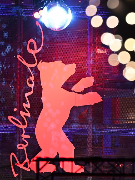 Das Berlinale-Logo ist einem Gebäude befestigt. Es zeigt einen roten Bären, der auf den Hinterbeinen steht. 