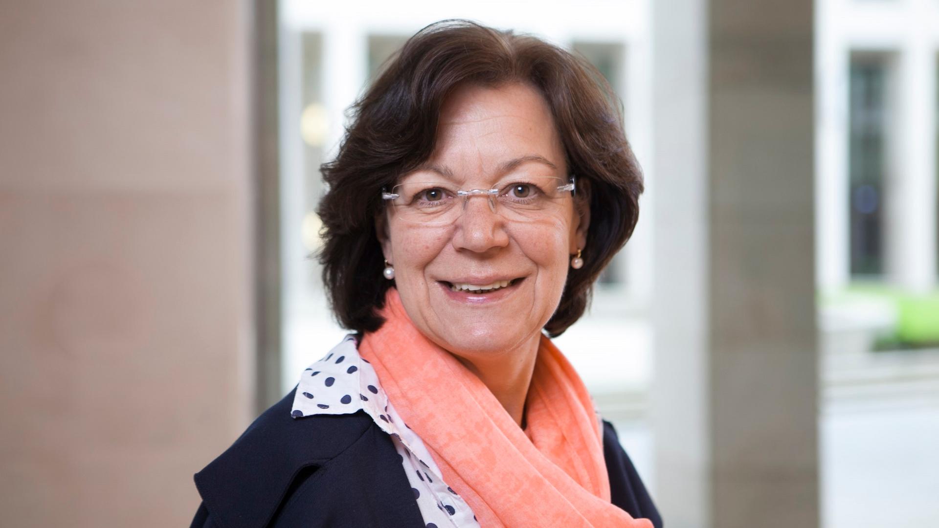 Porträt von Margret Schaaf, Vorsitzende des Bundesverbands Leselernhelfer. Sie hat braune, schulterlange Haare, trägt eine randlose Brille und lächelt in die Kamera.