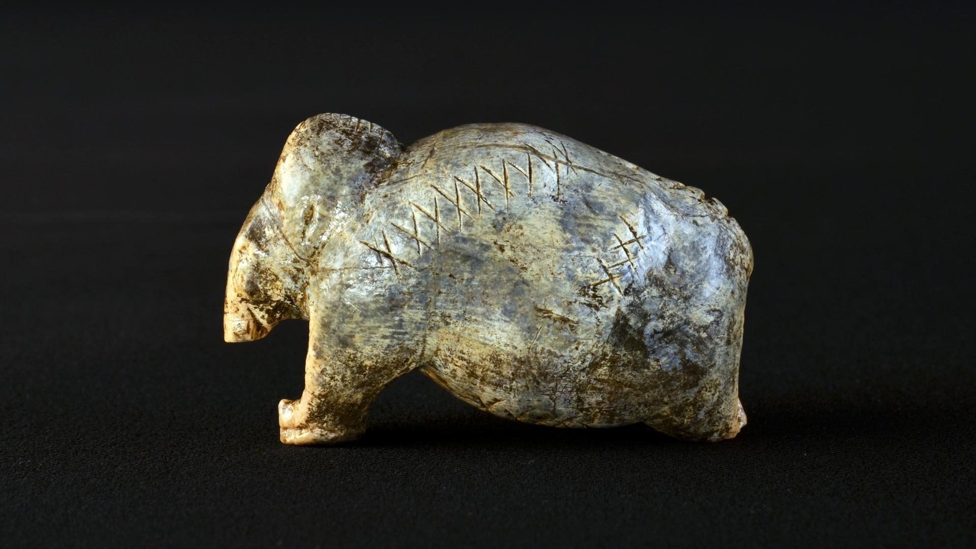 Die Mammut-Figurine aus der Vogelherd-Höhle ist etwa 40.000 Jahre alt und trägt auf ihrer Oberfläche mehrere Reihen von Kreuzen und Punkten.