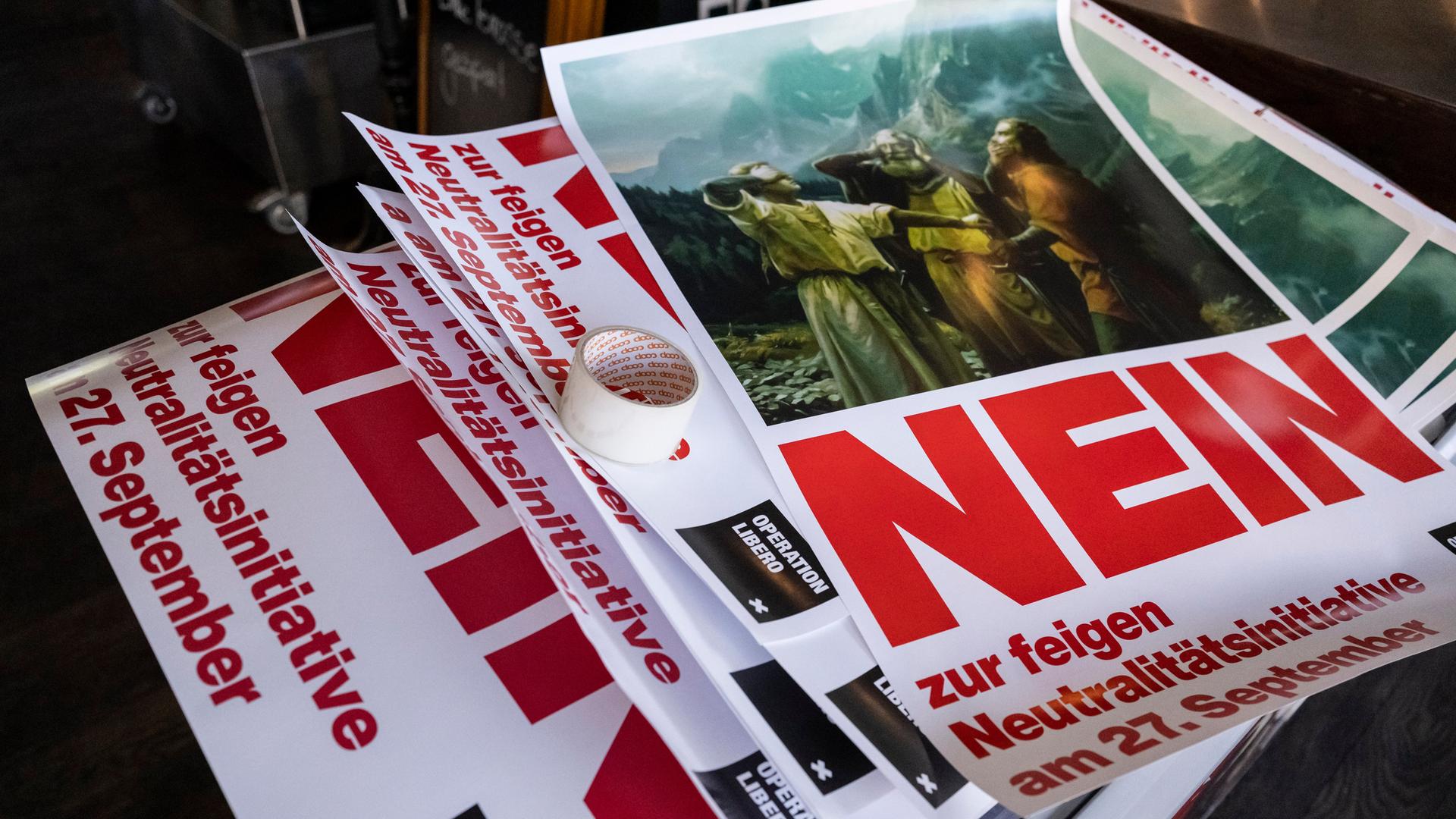 Abstimmungsplakate gegen die Neutralitätsinitiative liegen auf einem Stapel Abstimmungsplakate gegen die Neutralitätsinitiative liegen auf einem Stapel