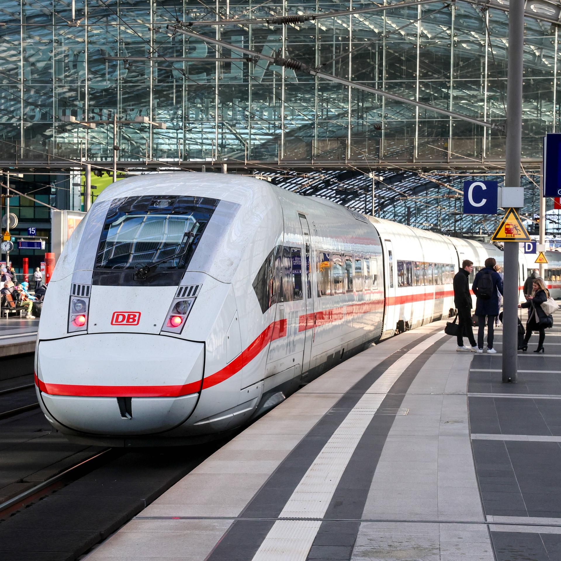 Ein ICE im Berliner Hauptbahnhof. Fahrgäste stehen auf dem Bahnsteig neben dem Zug.