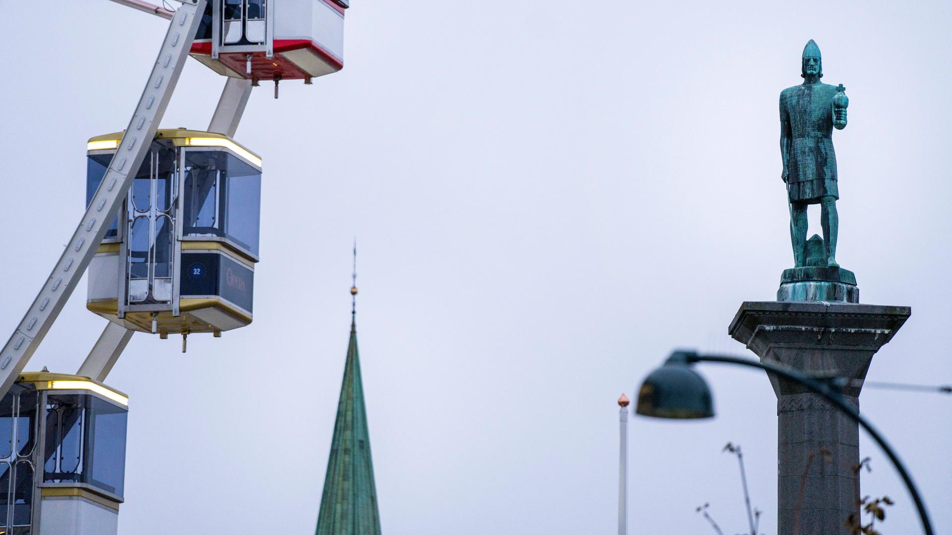 Denkmal für den Norwegen König Olav Trygvasson im norwegischen Trondheim, im Bild neben den Fahrkabinen eines Riesenrads. Denkmal für den Norwegen König Olav Trygvasson im norwegischen Trondheim, im Bild neben den Fahrkabinen eines Riesenrads.