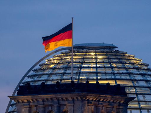 Die Reichstagskuppel mit der Deutschlandfahne. 