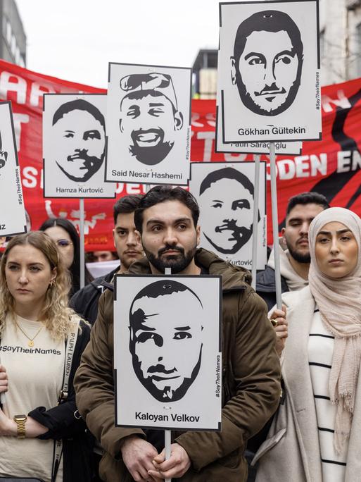 Menschen mit Porträts der Opfer und Spruchbändern gegen Rassismus nehmen am 17. Februar 2024 in Hanau an einem Protestmarsch zum Gedenken an die tödlichen Hanauer Schüsse von 2020 teil, vier Jahre nach dem Anschlag.