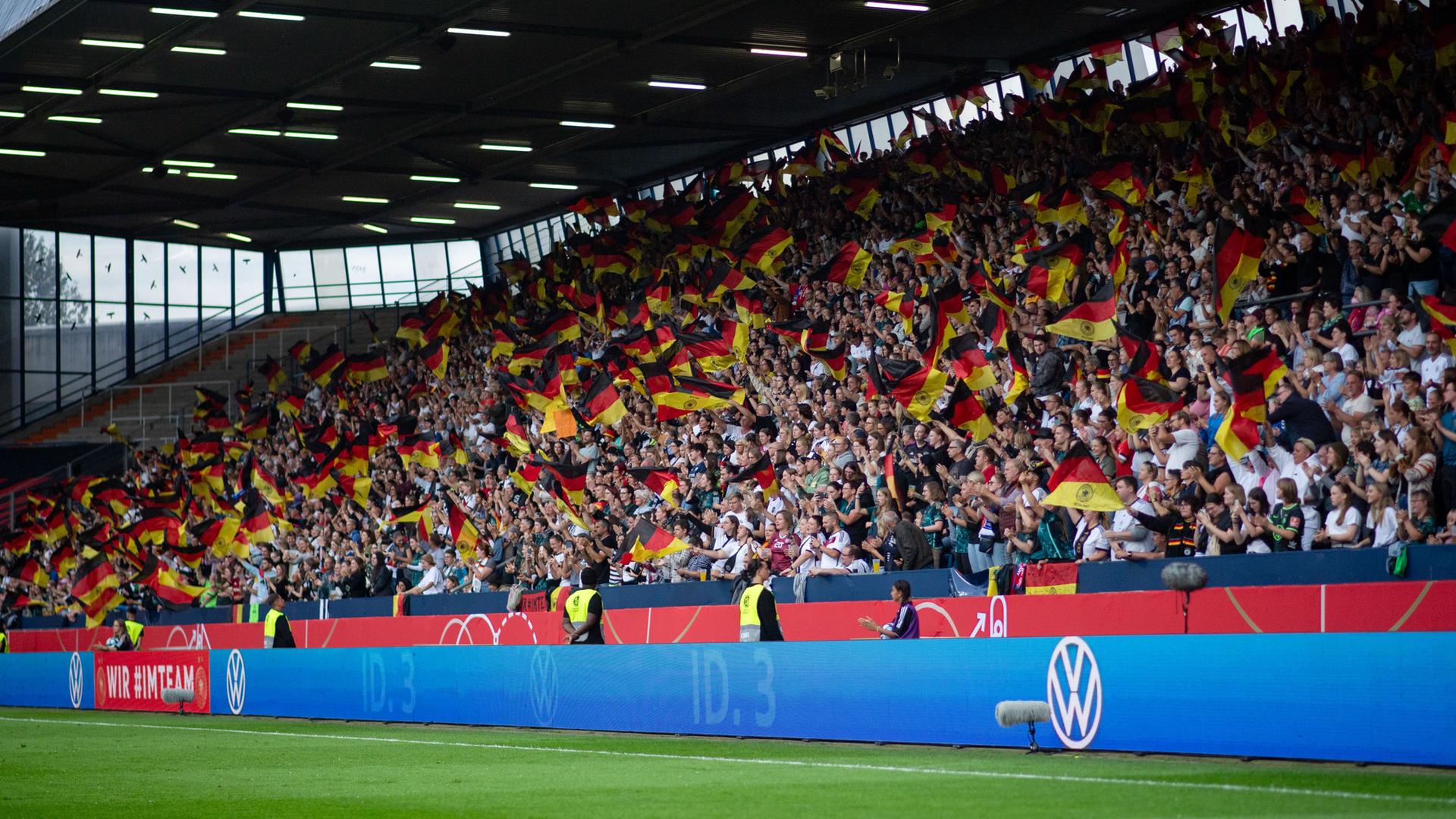 Fans von Deutschland jubeln über das Tor zum 1:0 und schwenken Fahnen/Flaggen  
