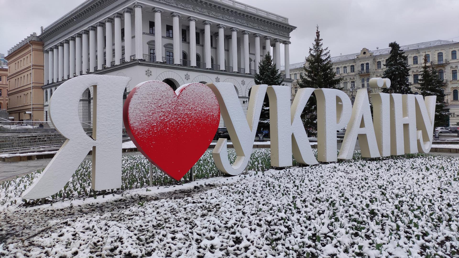 Dreidimensionale weiße Buchstaben mit einem roten Herz stehen schneebedeckt am Maidan Nezalezhnosti Square in Kiew