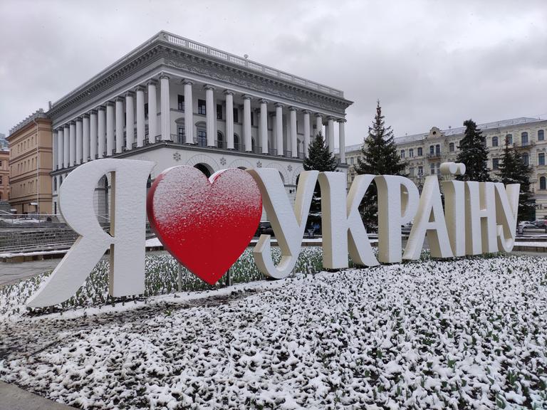 Dreidimensionale weiße Buchstaben mit einem roten Herz stehen schneebedeckt am Maidan Nezalezhnosti Square in Kiew