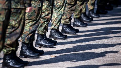 Das Bild zeigt die Beine und Füße von Bundeswehrsoldaten, die in einer Reihe stehen.