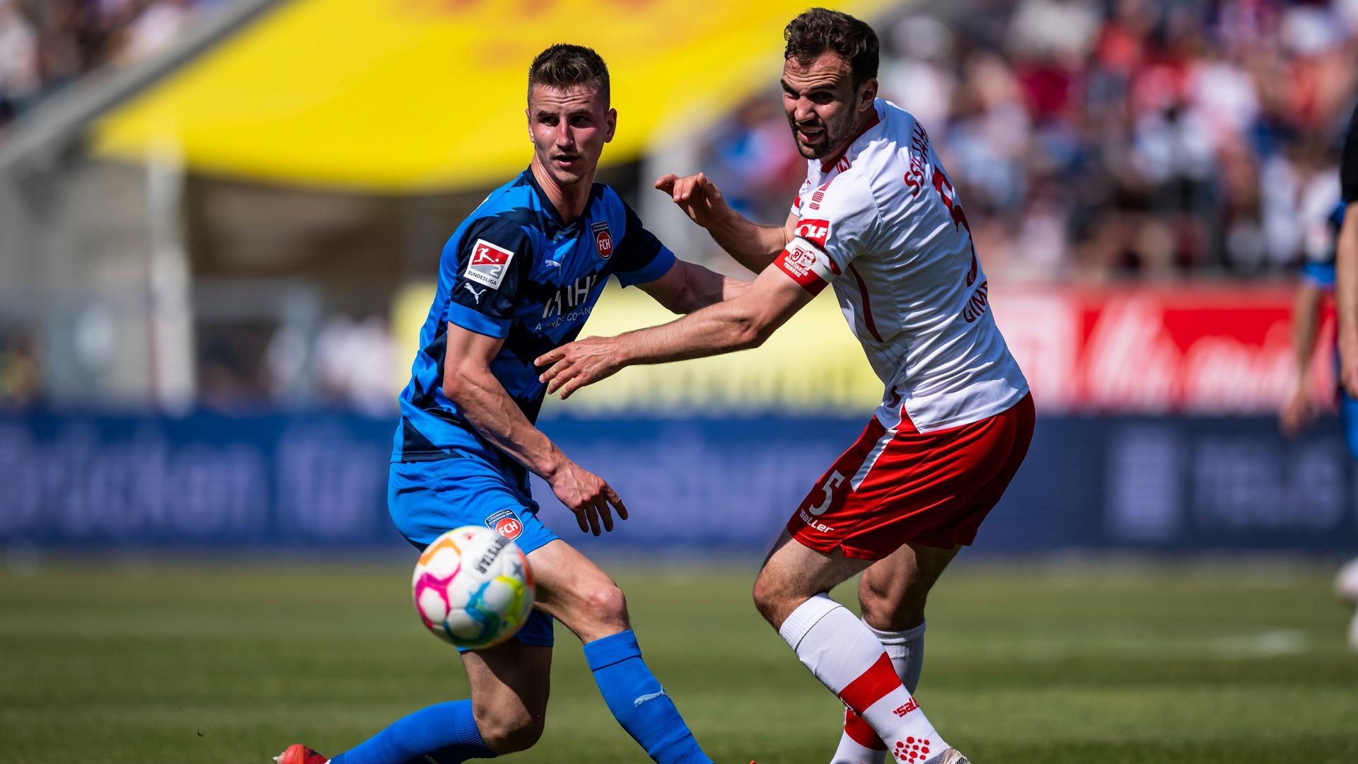 Jan Schöppner vom FC Heidenheim kämpft gegen Regensburgs Benedikt Gimber um den Ball. Jan Schöppner vom FC Heidenheim kämpft gegen Regensburgs Benedikt Gimber um den Ball.