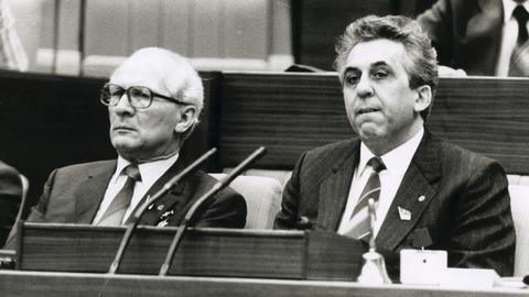 Schwarzweißaufnahme von Egon Krenz und Erich Honecker im Parlament.