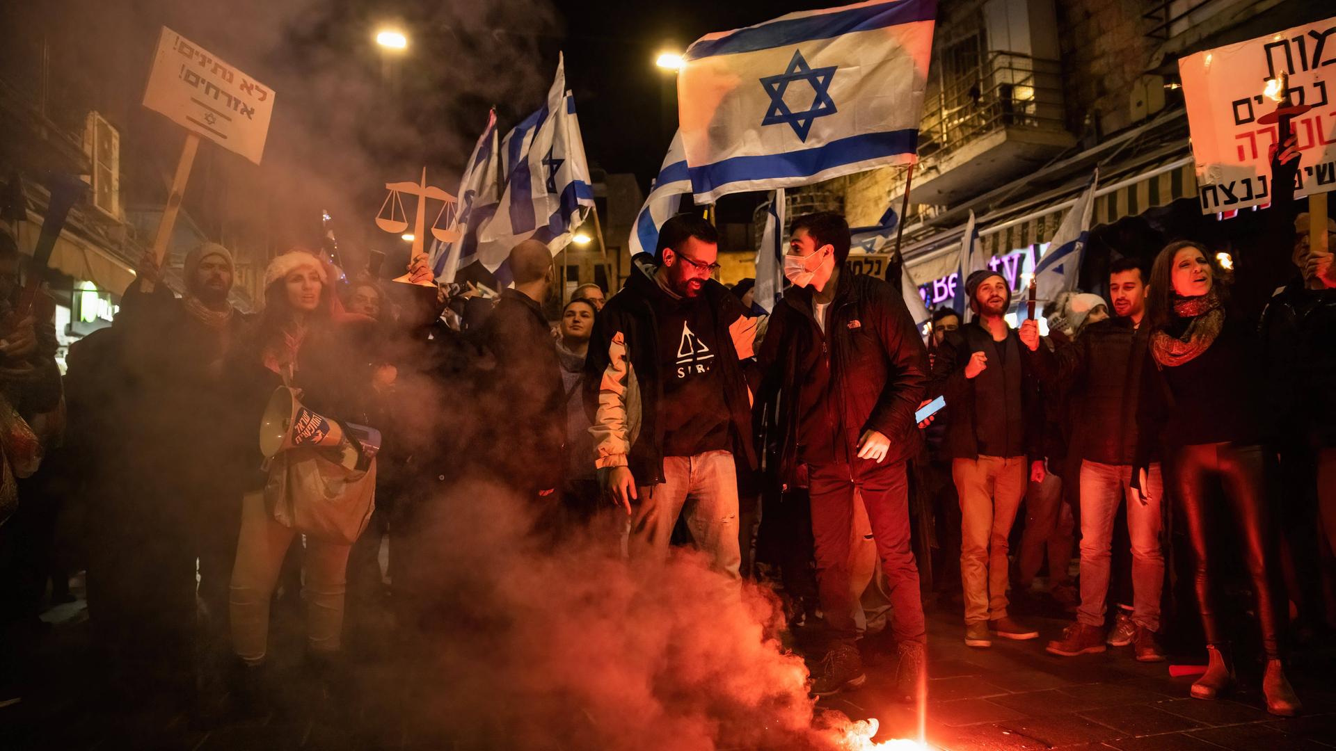 February 9, 2023, Jerusalem, Israel: Protesters light a torch in Jerusalem streets during the demonstration. Hundreds demonstrated against the new Israeli right-wing government and judicial overhaul in Jerusalem. Jerusalem Israel - ZUMAs197 20230209_zaa_s197_342 Copyright: xMatanxGolanx