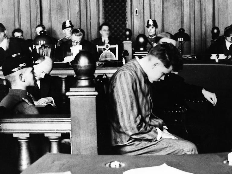 Ein Schwarz-Weiß-Foto zeigt den Niederländer Marinus van der Lubbe im Oktober 1933 beim Gerichtsprozess in Leipzig.