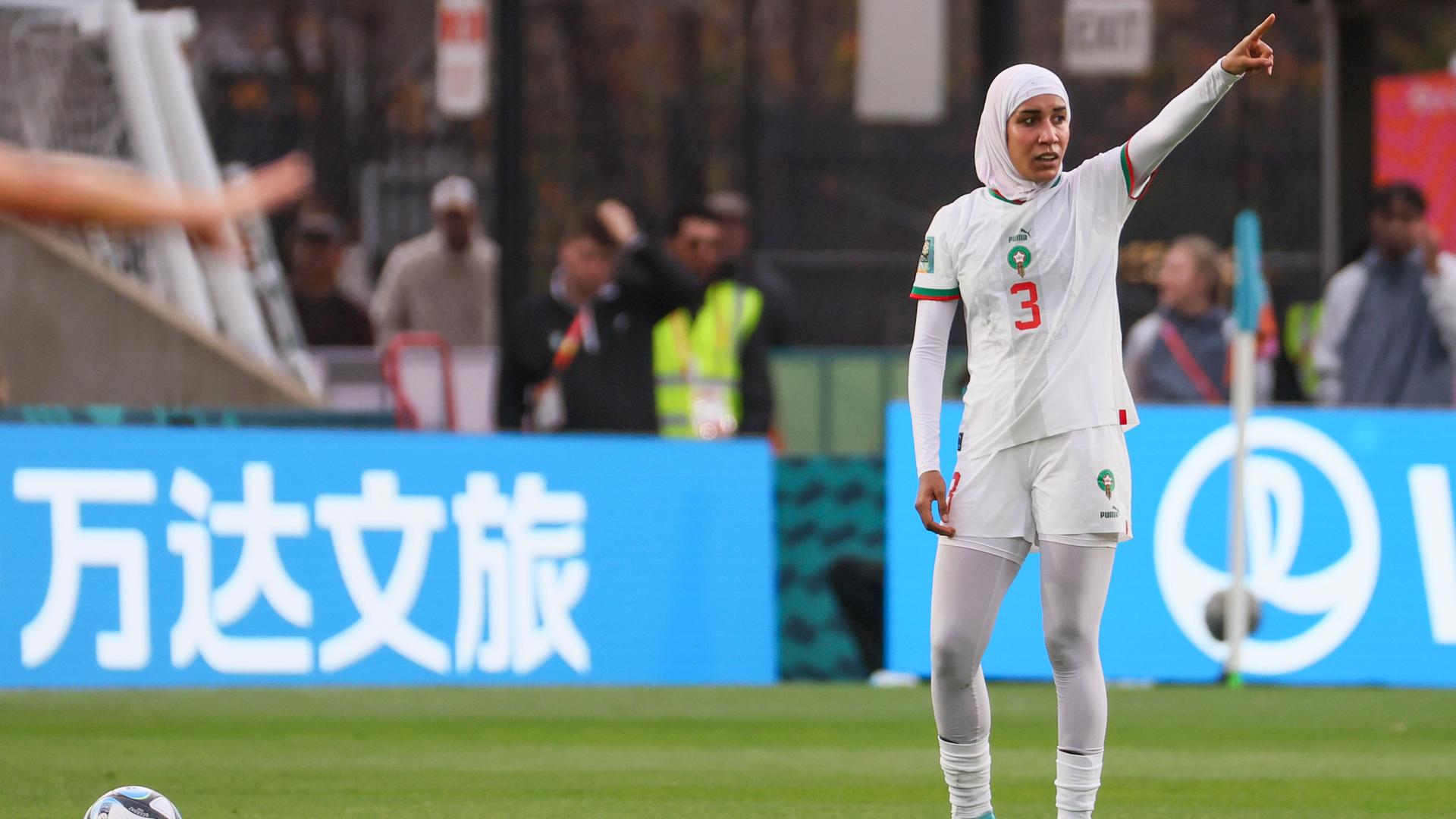 Eine Fußballspielerin mit einem Kopftuch Eine Fußballspielerin mit einem Kopftuch