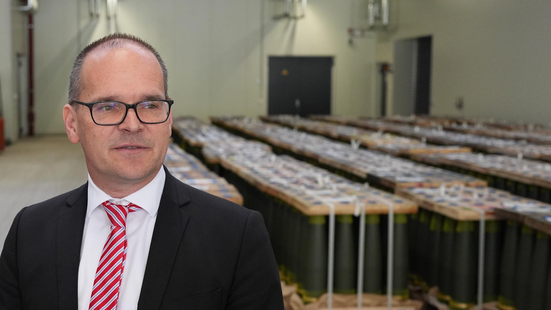 Grant Hendrik Tonne (SPD), Minister für Wirtschaft, Verkehr und Bauen in Niedersachsen, steht vor Artilleriegeschossen vom Kaliber 155 mm in der Munitionsfabrik LAP des Rüstungsunternehmens Rheinmetall.