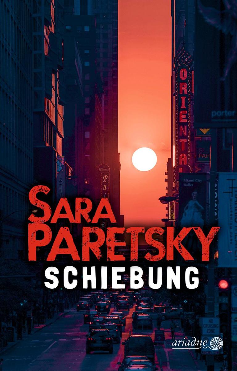 Das Buchcover von Sara Paretskys Krimi, "Schiebung". Es zeigt eine in rötlicher Farben getauchte Straßenschlucht, am Horizont ein Himmelskörper, der für diese Farbe sorgt. Das Bild ist auf der Krimibestenliste von Deutschlandfunk Kultur.