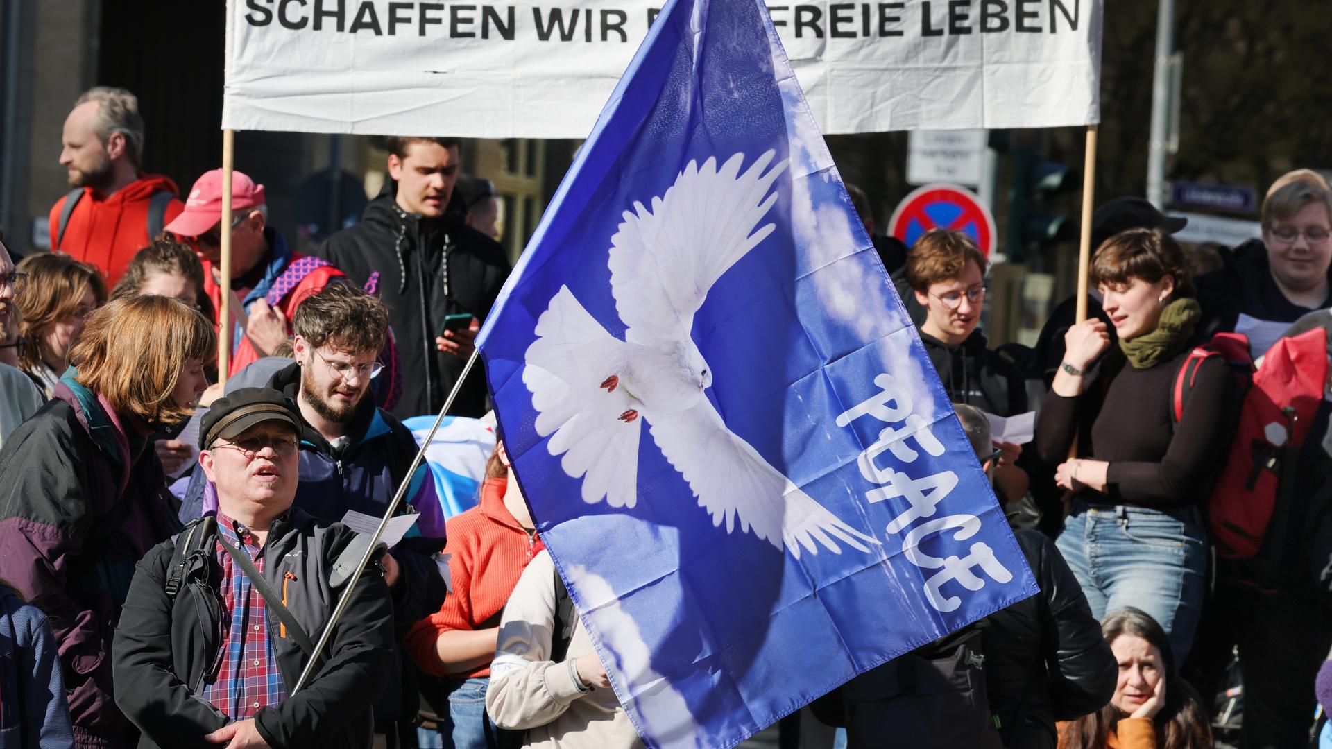 Teilnehmer einer Kundgebung anlässlich der Ostermärsche der Friedensbewegung in Thüringen ziehen durch die Innenstadt von Jena.
