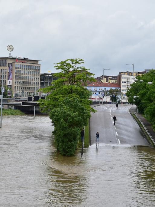 Starkregen sorgt in Saarbrücken in der Saar für Hochwasser am 18.5.2024. Im Stadtgebiet sind die Saaranlagen und die Stadtautobahn überflutet, das Hochwasser wird dabei zum Fotomotiv und zieht Schaulustige an, während in den betroffenen Strassen die Aufräumarbeiten beginnen.