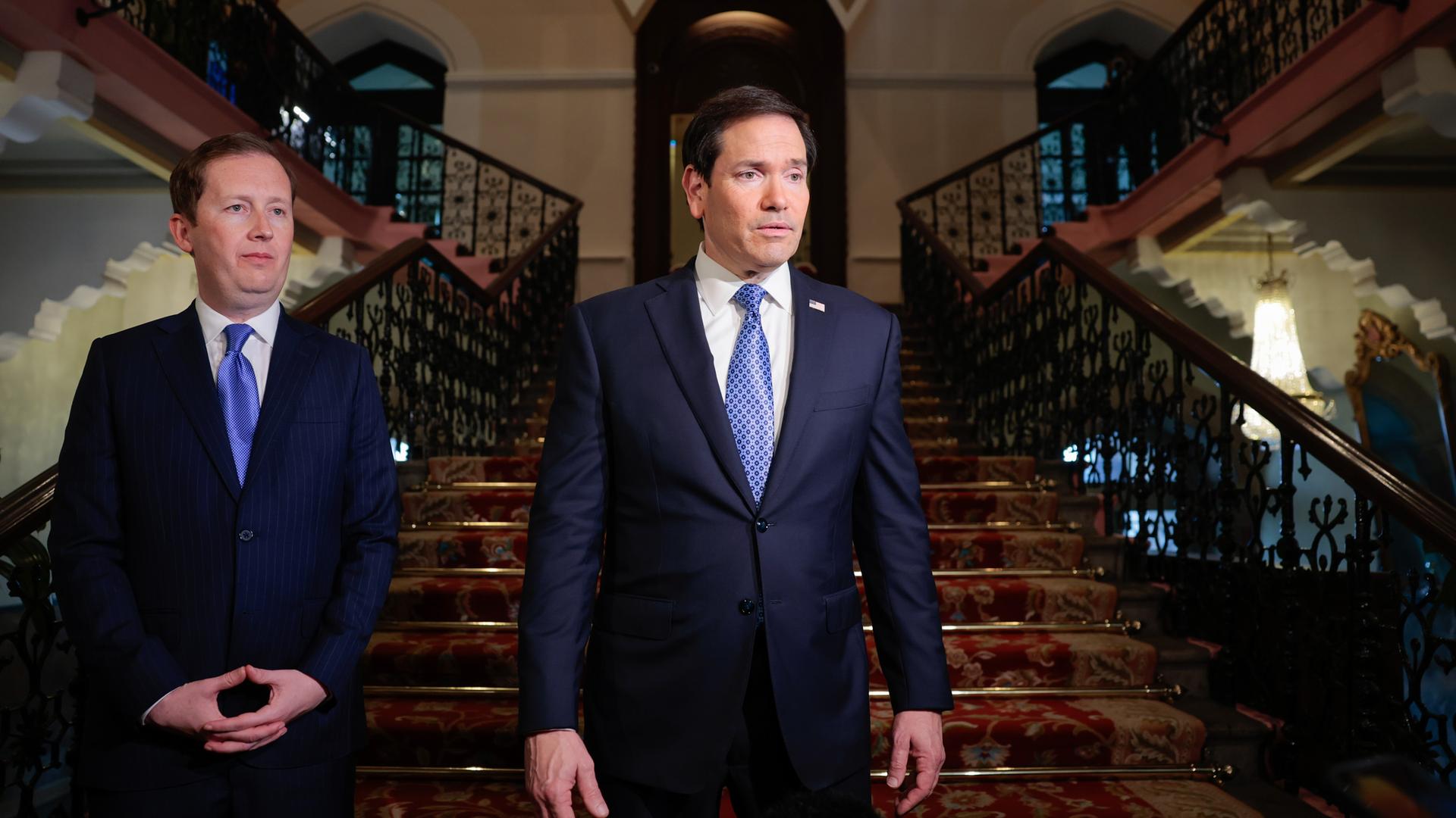 US-Außenminister Rubio und ein Mitarbeiter stehen in einer Halle im Taj Mahal Palace Hotel in Mumbai.