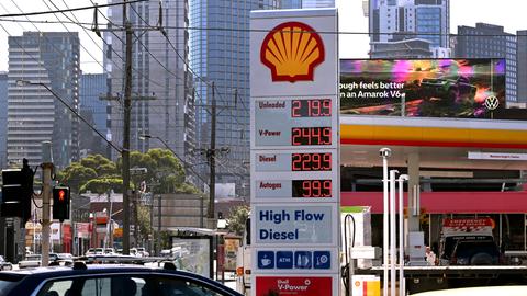 Ein Schild an einer Tankstelle in Melbourne zeigt im März 2026 die aufgrund des Nahostkonflikts stark gestiegenen Preise für Benzin und Diesel an. Im Hintergrund sind Hochhäuser zu sehen.