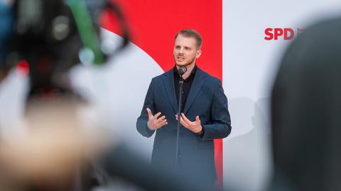 Tim Klüssendorf (SPD) spricht bei einer Pressekonferenz  und gestikuliert. 