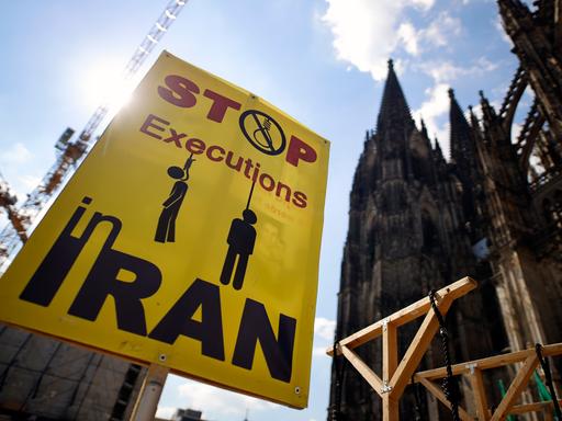 Eine Demonstration von Gegnern des Mullah-Regimes in Teheran fordert Solidarität mit der Opposition im Iran, die Abschaffung der Todesstrafe und einen Umsturz. Sie halten iranische Flaggen und haben einige Galgen aus Holz aufgebaut, welche die martiallschen Hinrichtungsmethoden im Iran veranschaulichen sollen. Die Demo wurde mit Corona-Auflagen zugelassen auf dem Roncalliplatz direkt am Kölner Dom. Köln, 29.05.2021