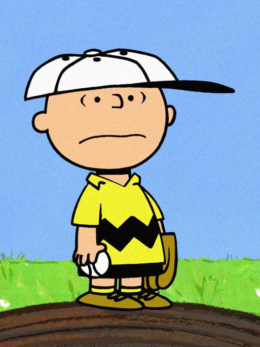 Die Zeichentrickfigur Charlie Brown steht einsam auf einer kleiner Erhebung und blickt ernüchtert um sich