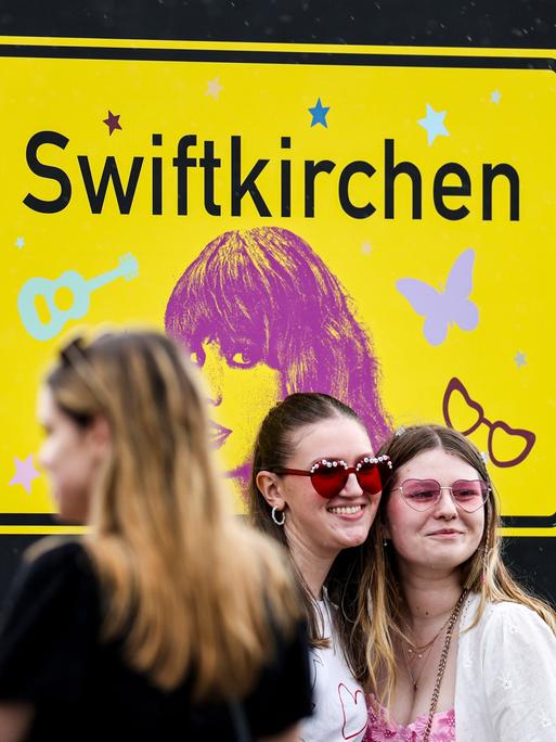 Fans lassen sich vor dem Swiftkirchen-Schild fotografieren. Im Rahmen der Eras-Tour tritt Swift in Deutschland unter anderem in Hamburg und München auf.