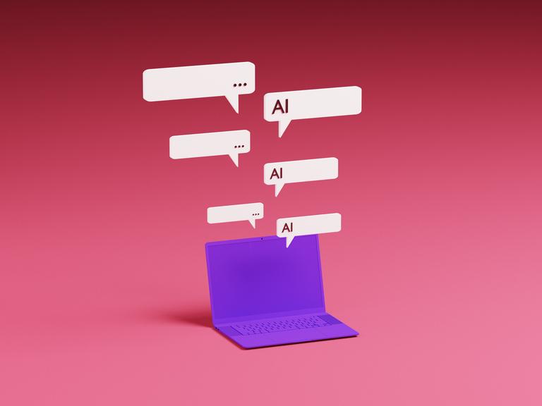 Ein violetter Laptop mit darüber schwebenden Sprechblasen eines KI-Chatbot-Assistenten.