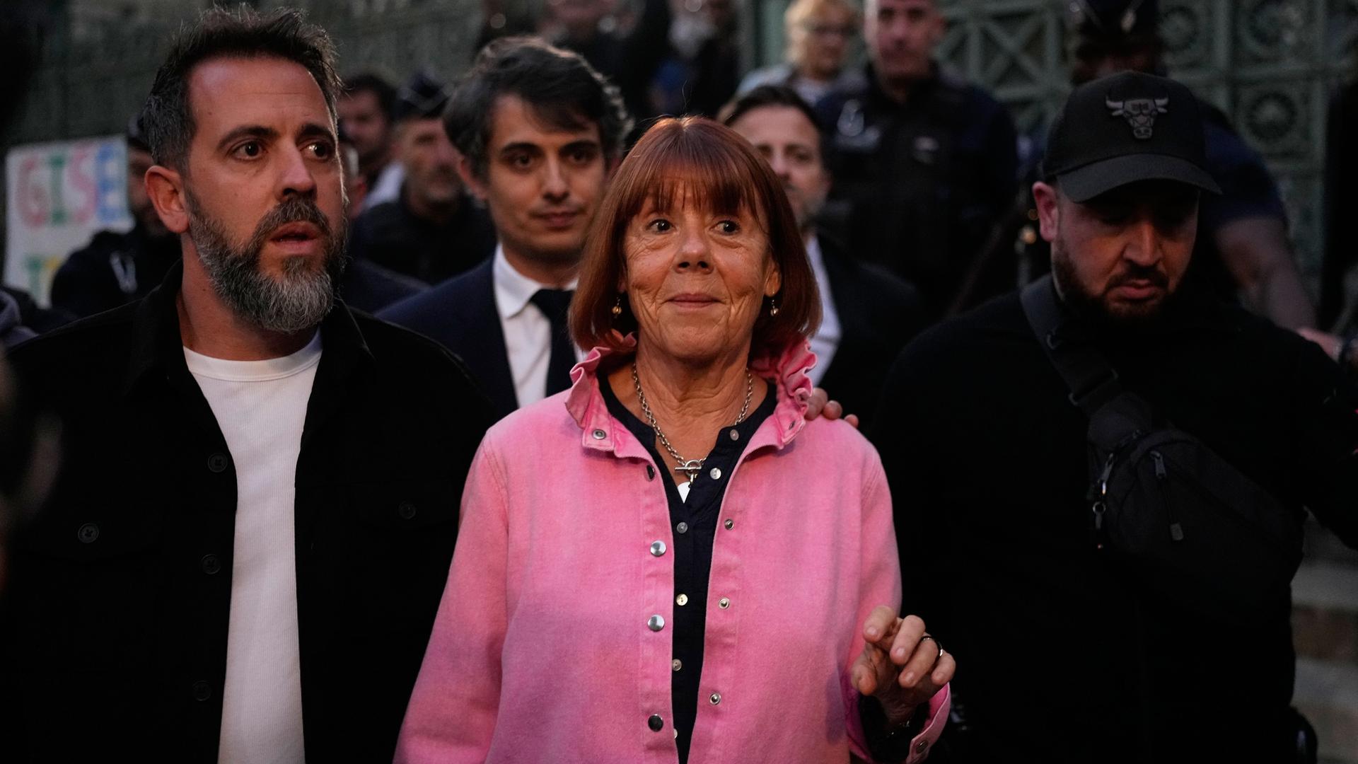 Eine lächelnde Gisèle Pelicot verlässt einen Gerichtssaal.