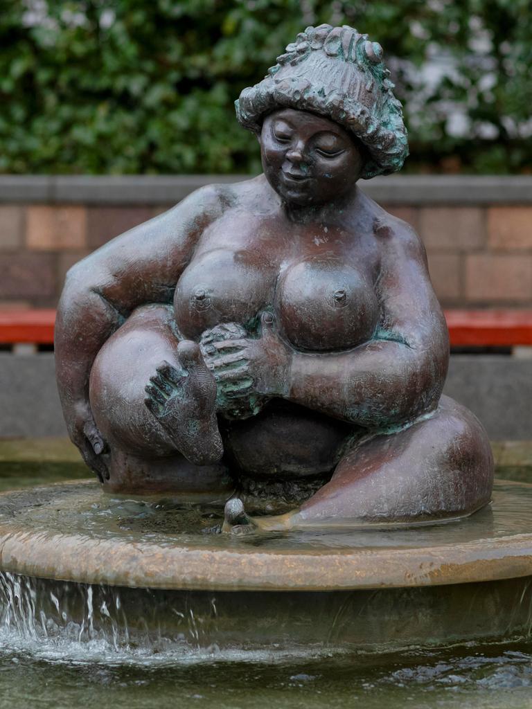 Die Brunnenfigur einer dicken nackten Frau beim Baden.