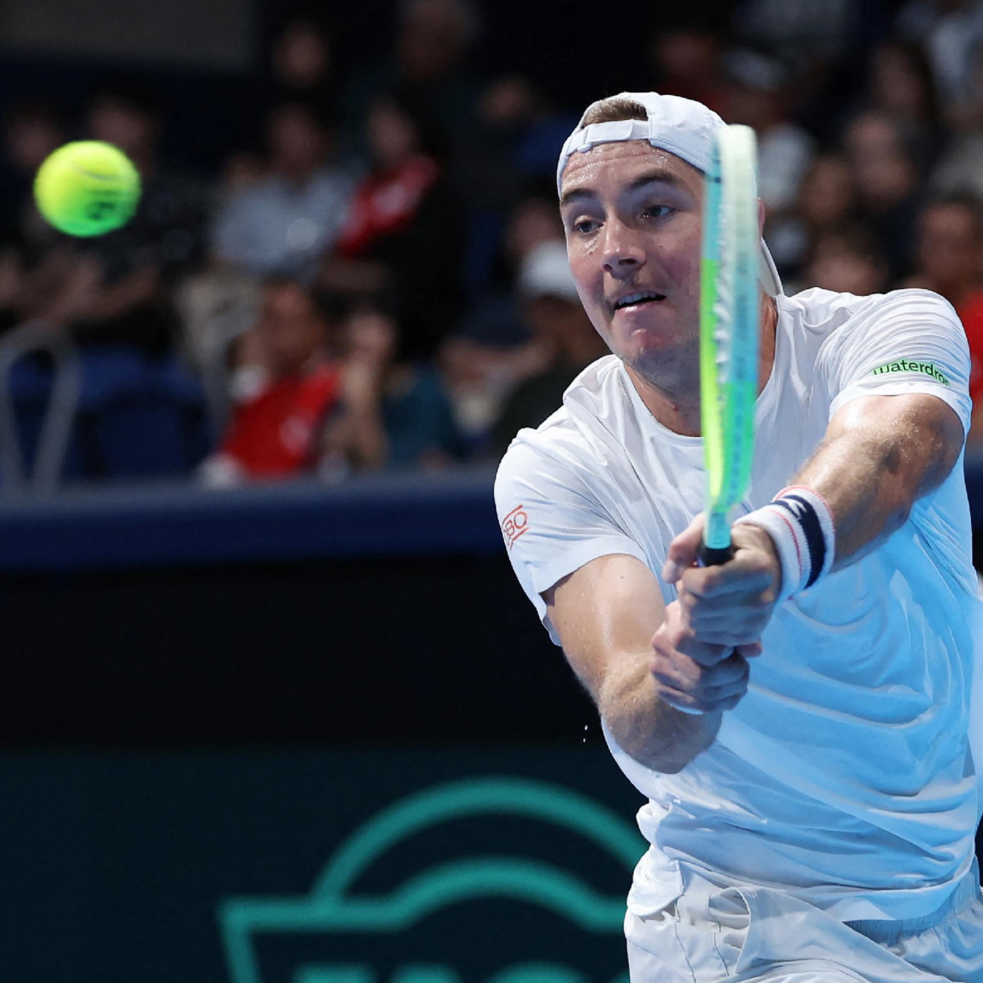 Jan-Lennard Struff schlägt einen Ball im Spiel gegen den Japaner Yoshihito Nishioka, der nicht im Bild  ist.