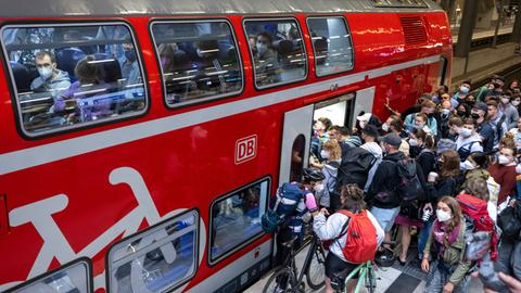 Vor einem Regionalzug am Berliner Hauptbahnhof drängen sich zahlreiche Reisende.