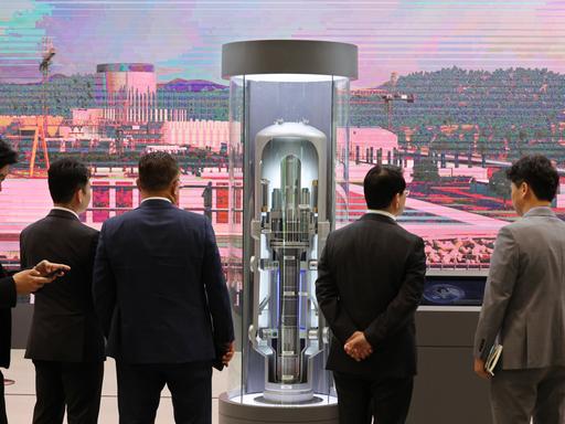 Besucher einer Messe für Nuklearenergie blicken auf das Modell eines Small Modular Reactor (SMR) in der südkoreanischen Hafenstadt Busan. Das Modell ist ca. 2 Meter hoch.