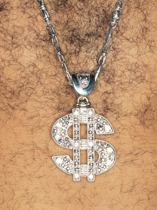 Ein Mann mit behaarter Brust, der ein glitzernde Kette mit einem US-Dollar-Zeichen als Anhänger trägt.