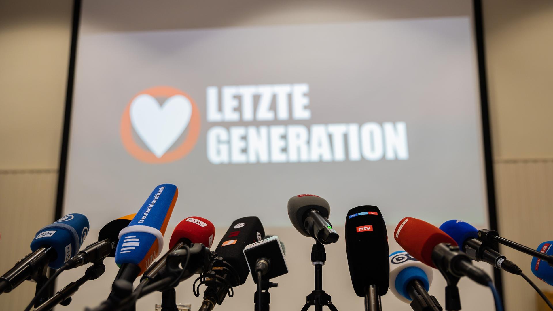 Mikrofone stehen vor Beginn einer Pressekonferenz der Letzten Generation in der Reformationskirche in Berlin-Moabit auf einem Tisch.