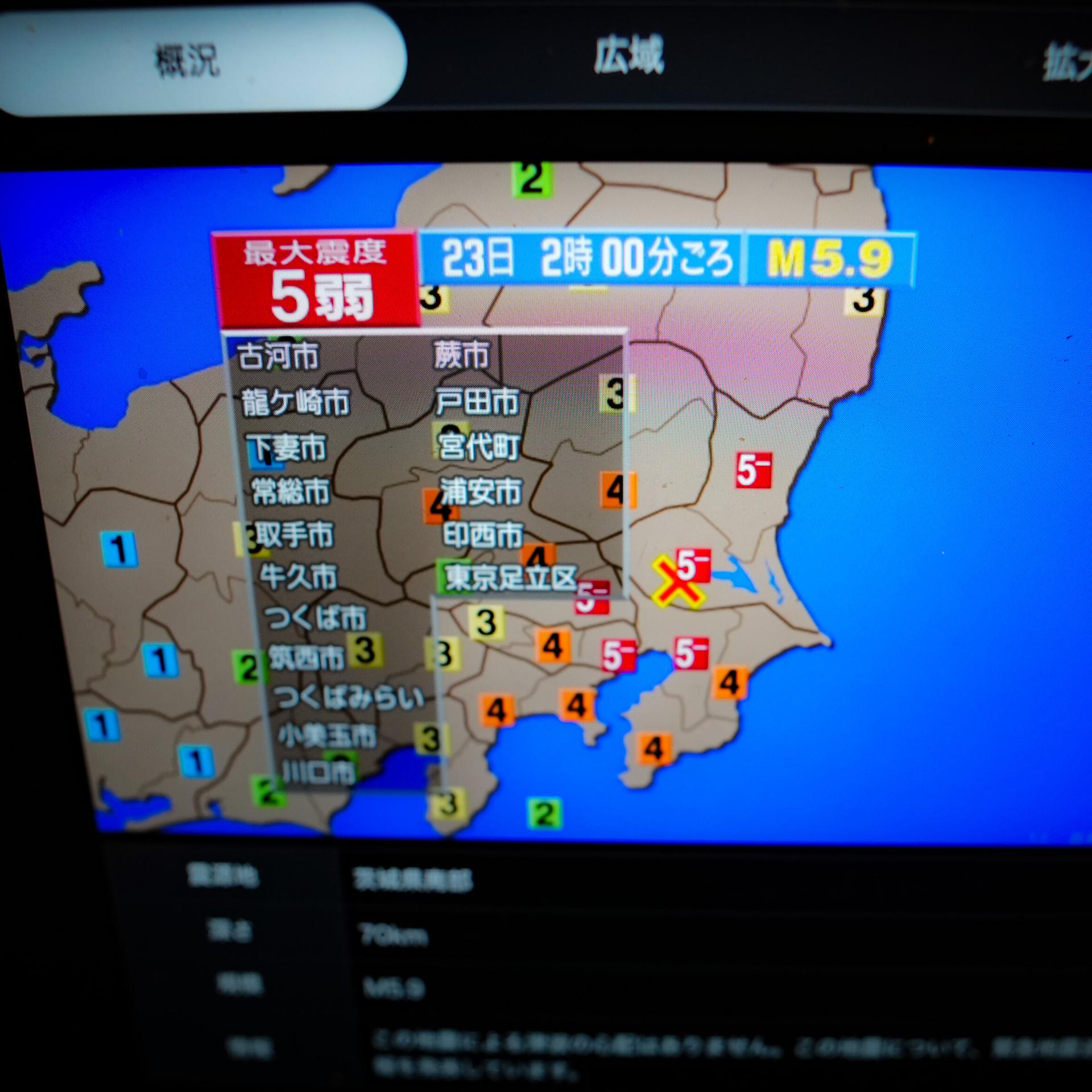 Auf einen Bildschirm werden mit Informationen zum Erdbeben in Japan gezeigt. 