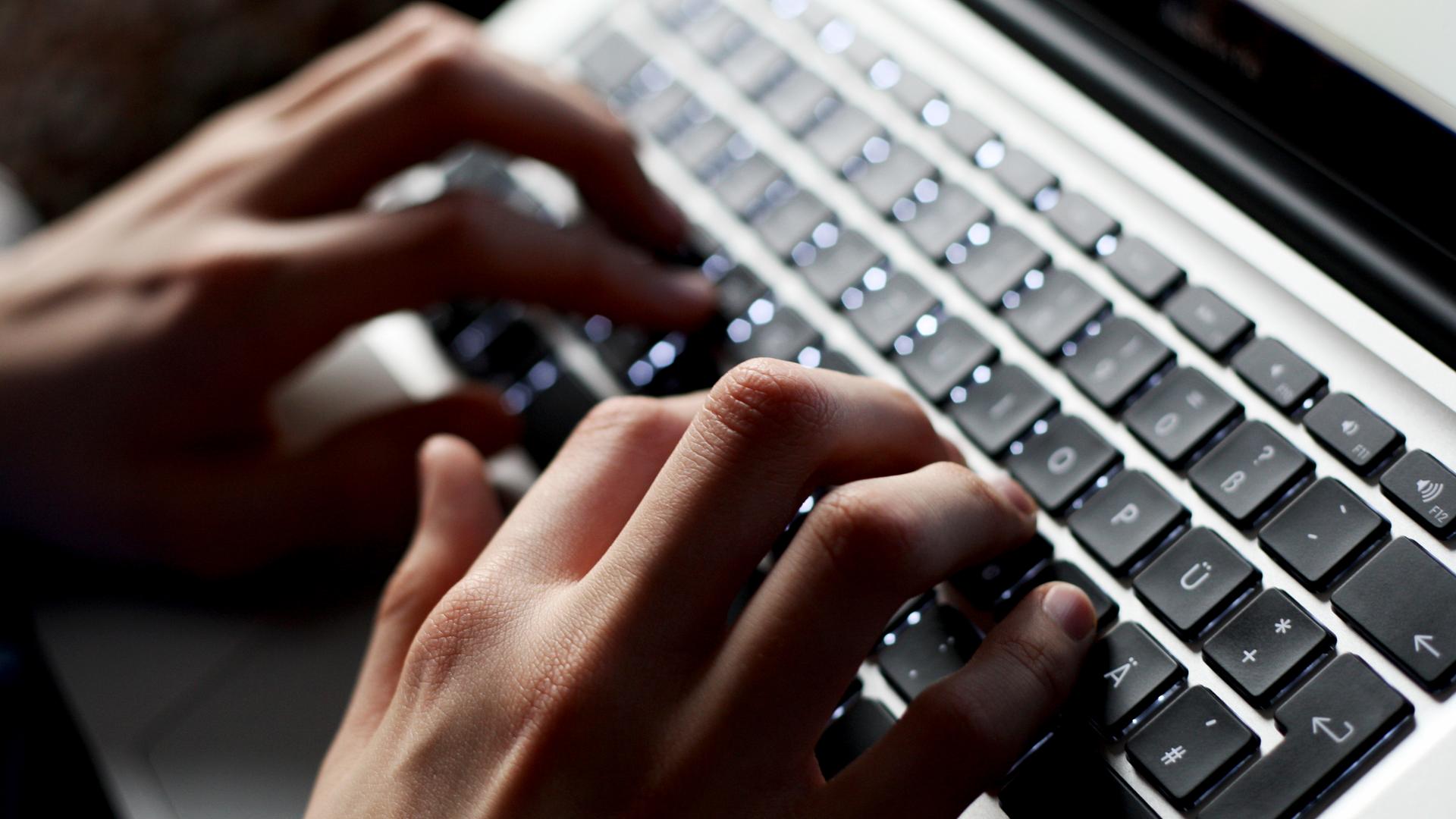 Hände tippen auf einer Tastatur. 