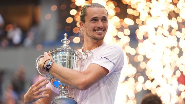 Das Foto zeigt Alexander Zverev mit seinem Sieger-Pokal bei dem Tennis-Turnier US-Open.