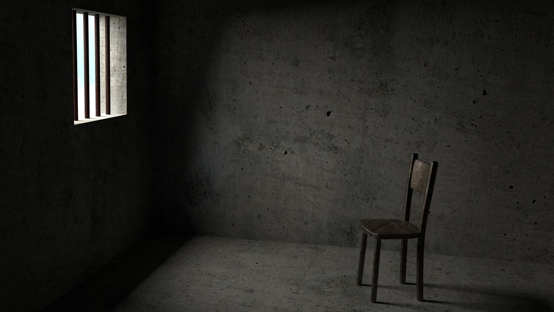 Illustration: Ein leerer Stuhl in einer Gefängniszelle.