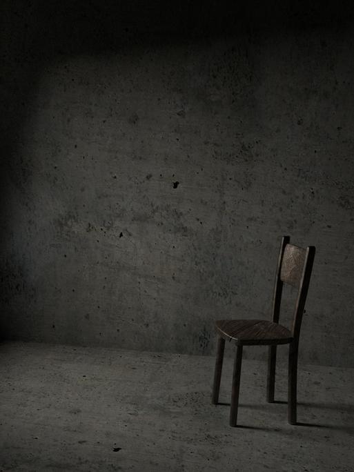 Illustration: Ein leerer Stuhl in einer Gefängniszelle.