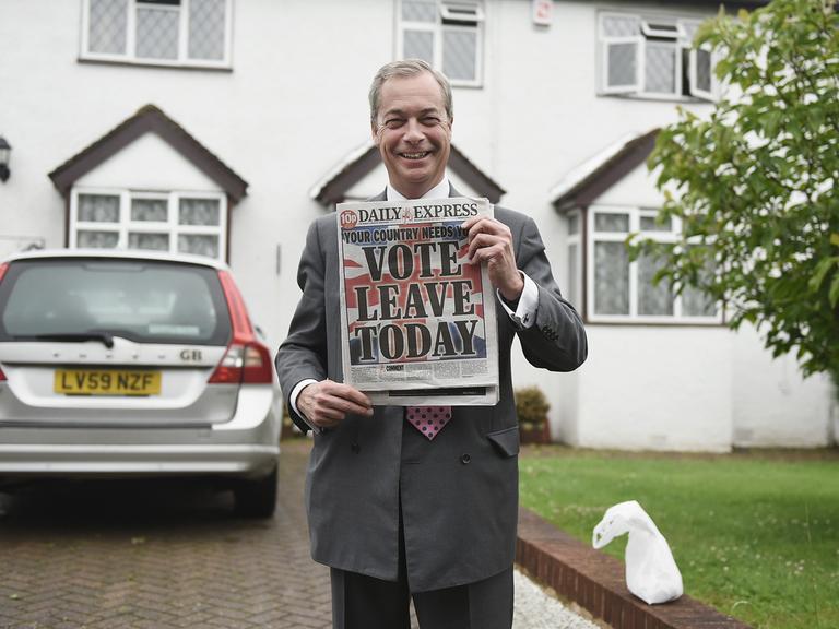 Nigel Farage hält am Tag des Brexit-Referendums, dem 23.6.2016, die Zeitung „Daily Express“ hoch. Auf dem Titelblatt steht: „Vote Leave Today“. Im Hintergrund ist sein Haus zu sehen. 